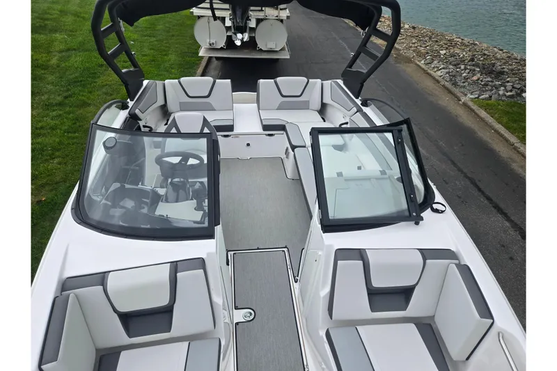 Slide: The Image of 2024 Yamaha Boats AR220 interior with sleek seating and modern design by the water. - 18