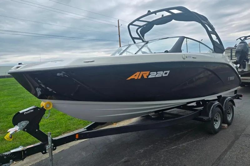 Slide: The Image of 2024 Yamaha Boats AR220 on trailer, sleek design, black and white exterior. - 5