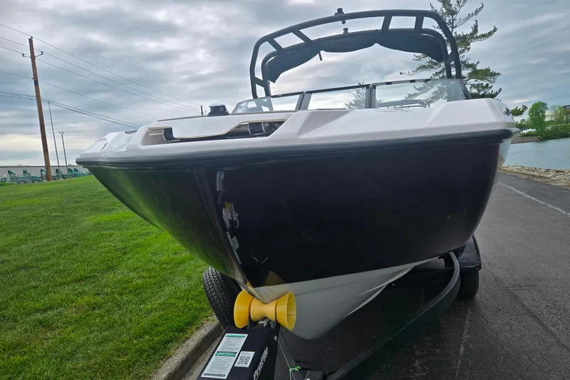 Slide: The Image of 2024 Yamaha Boats AR220 on trailer, parked near a lake under cloudy skies. - 6