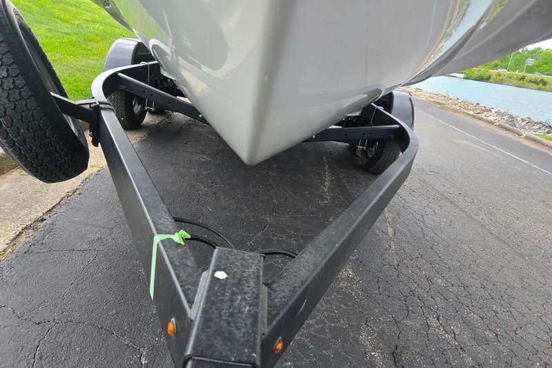 Slide: The Image of 2024 Yamaha Boats AR220 on trailer near water, showcasing hull and trailer details. - 7