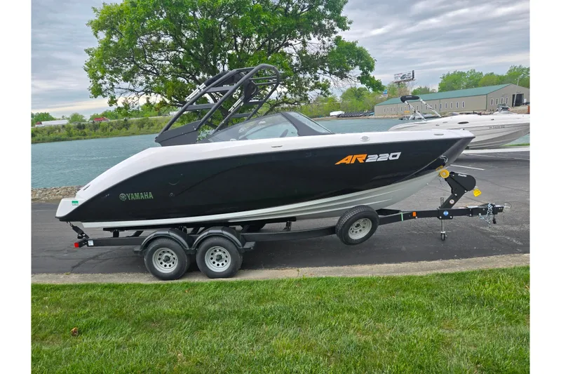 Slide: The Image of 2024 Yamaha Boats AR220 on trailer, parked near a scenic waterfront. - 9