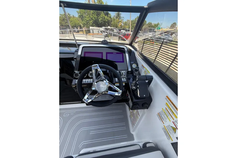 Slide: The Image of 2026 Granfort 300 GTX boat cockpit with modern steering wheel and control panel. - 10