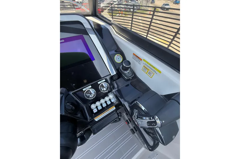 Slide: The Image of Cockpit of 2026 Granfort 300 GTX boat with modern controls and navigation display. - 11