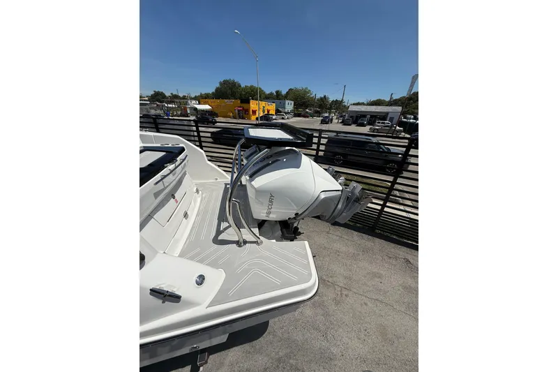 Slide: The Image of 2026 Granfort 300 GTX boat with Mercury outboard motor, parked outdoors. - 2