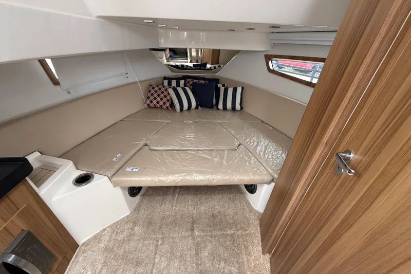 Slide: The Image of Luxurious interior cabin of 2026 Granfort 300 GTX boat with plush bedding and cushions. - 6