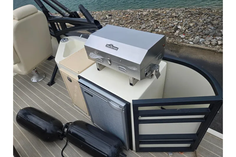 Slide: The Image of 2022 Lexington 621TT Extreme boat with grill and mini fridge setup. - 10