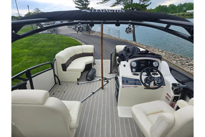 Slide: The Image of Luxurious 2022 Lexington 621TT Extreme pontoon boat interior with plush seating and modern controls. - 11