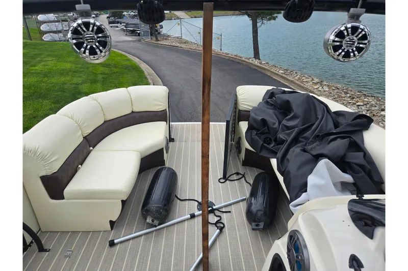 Slide: The Image of 2022 Lexington 621TT Extreme boat interior with seating, speakers, and lake view. - 14