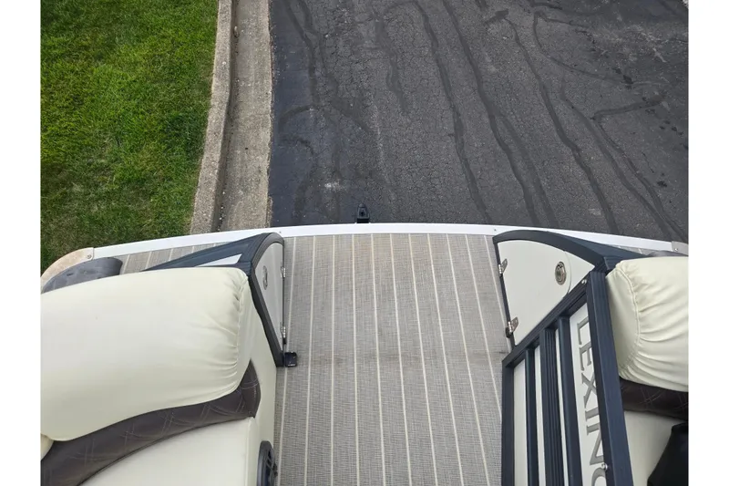 Slide: The Image of 2022 Lexington 621TT Extreme boat deck with cushioned seating and railing. - 15