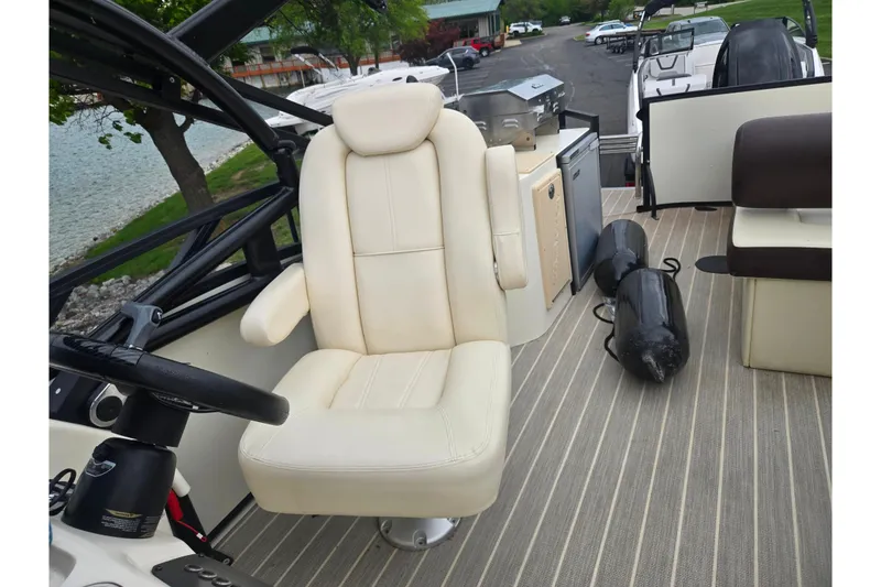 Slide: The Image of 2022 Lexington 621TT Extreme boat interior with captain's chair and deck accessories. - 20