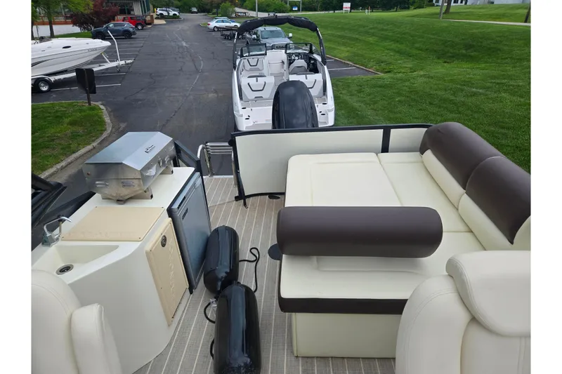 Slide: The Image of 2022 Lexington 621TT Extreme pontoon boat with seating and outdoor kitchen setup. - 21