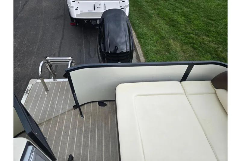 Slide: The Image of 2022 Lexington 621TT Extreme boat interior with seating and ladder, parked on grass. - 22