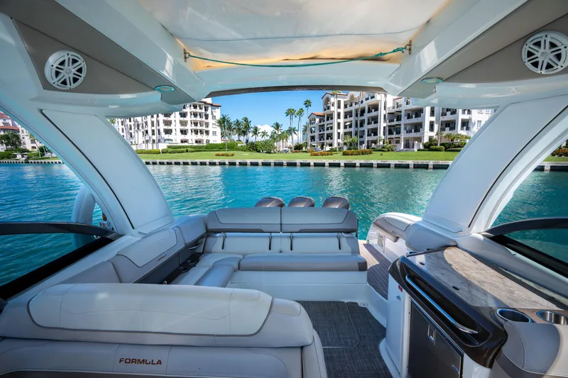Slide: The Image of 2018 Formula 350 Crossover Bowrider OB on serene water, luxury seating, coastal view. - 14