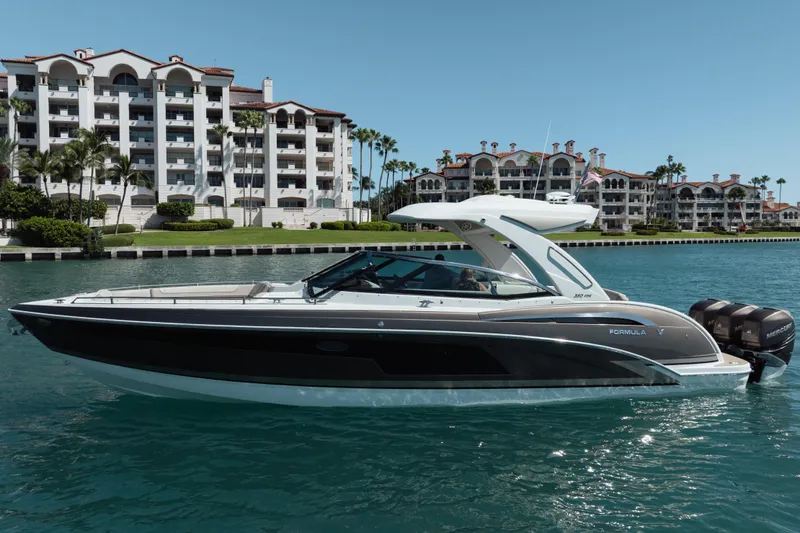 Slide: The Image of 2018 Formula 350 Crossover Bowrider OB cruising near luxury waterfront apartments. - 3