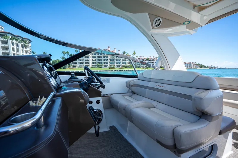 Slide: The Image of 2018 Formula 350 Crossover Bowrider OB interior with luxurious seating and waterfront view. - 30