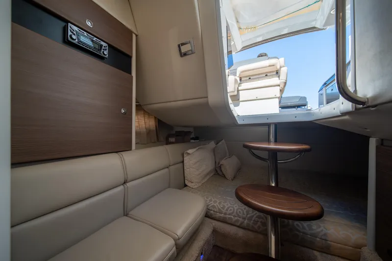 Slide: The Image of Interior of 2018 Formula 350 Crossover Bowrider OB, featuring cozy seating and wooden steps. - 39