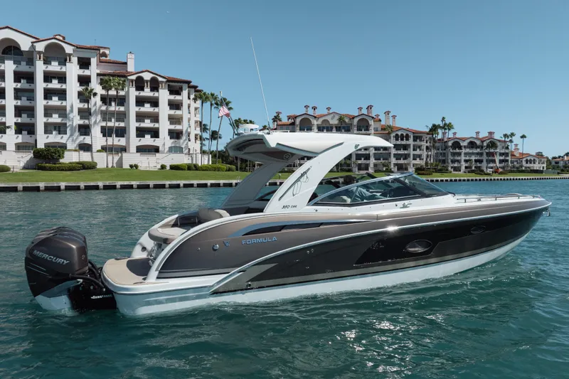 Slide: The Image of 2018 Formula 350 Crossover Bowrider OB on water, luxury waterfront buildings in background. - 6