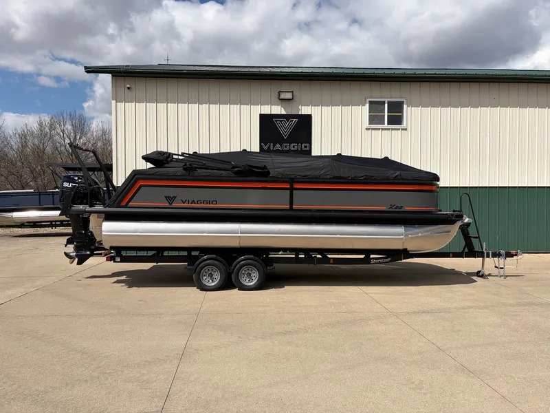 Slide: The Image of Viaggio Lago X-U 22 boat 2026 on trailer in front of building. - 26