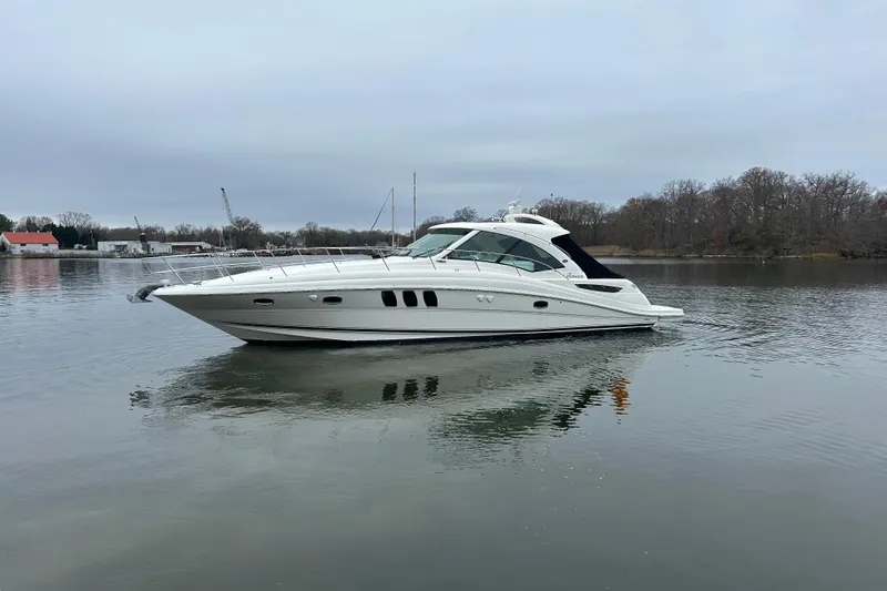Slide: The Image of 2007 Sea Ray 48 Sundancer yacht on calm water, overcast sky. - 3