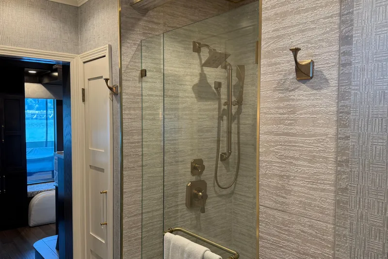 Slide: The Image of Luxurious bathroom with glass shower enclosure in a 2020 Thoroughbred 20 x 102 model. - 10