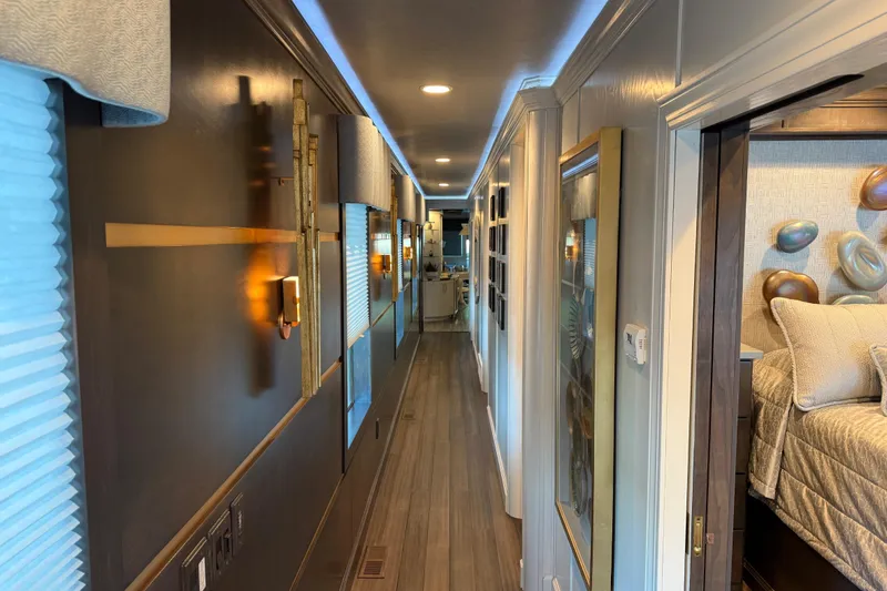 Slide: The Image of Luxurious interior hallway of a 2020 Thoroughbred 20 x 102 RV with modern decor. - 13