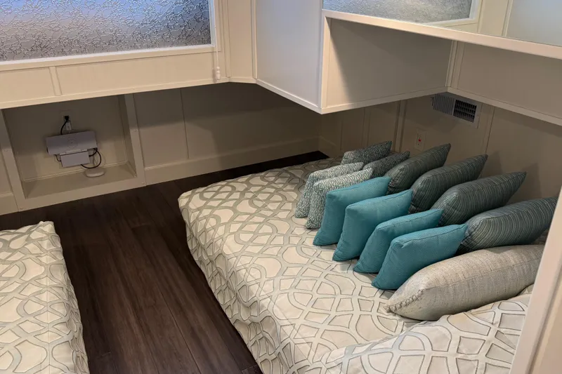 Slide: The Image of Modern Thoroughbred 20 x 102 interior with patterned bedding and teal accent pillows, 2020 model. - 16