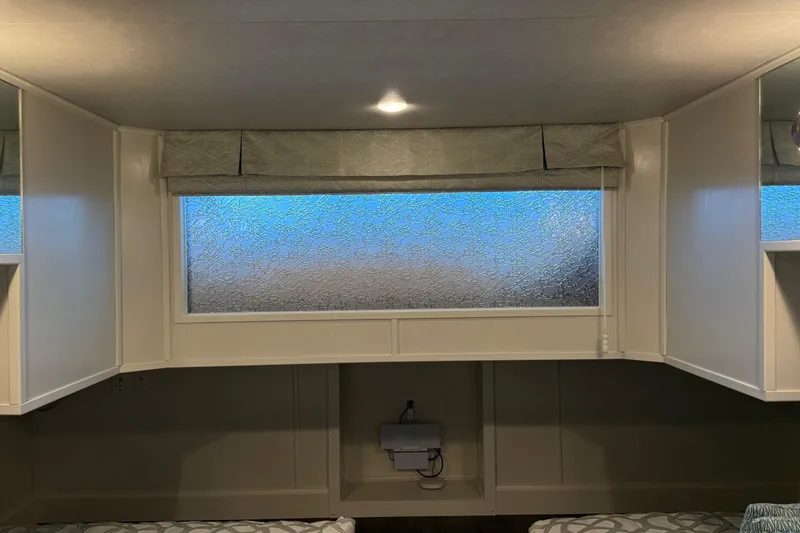 Slide: The Image of Interior of 2020 Thoroughbred 20 x 102 RV with frosted window and cabinets. - 17