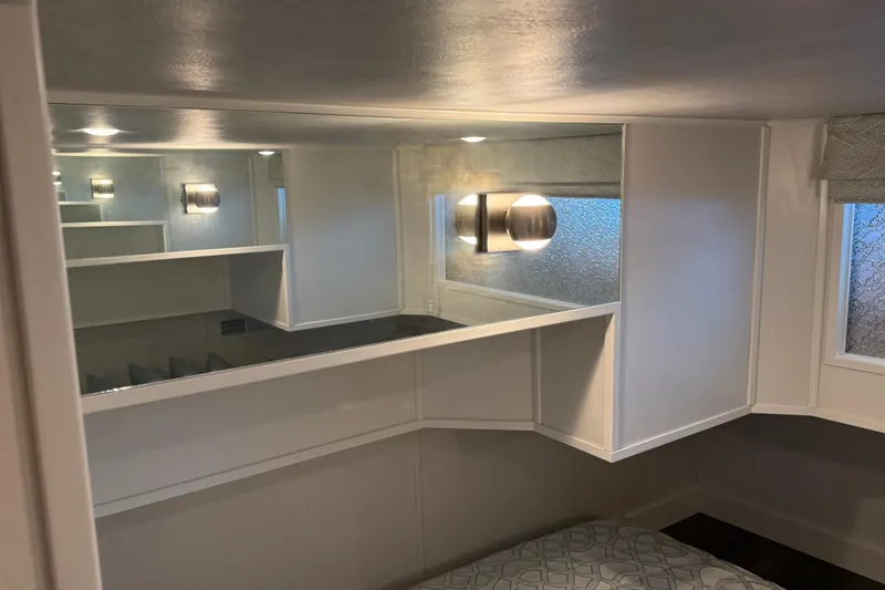 Slide: The Image of Modern interior of a 2020 Thoroughbred 20 x 102 trailer with sleek lighting and shelving. - 18