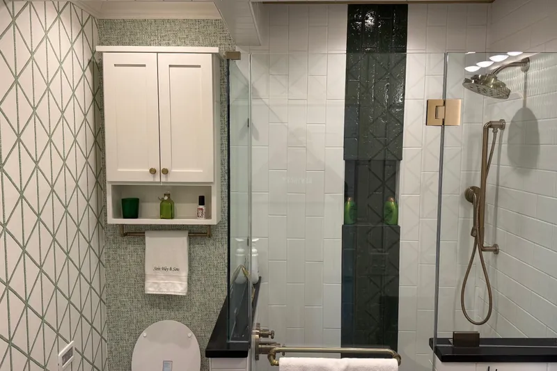 Slide: The Image of Modern bathroom with white cabinetry, geometric wallpaper, and glass shower enclosure, Thoroughbred 20 x 102, 2020. - 19