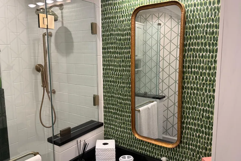 Slide: The Image of Modern bathroom with green mosaic tiles, glass shower, and elegant mirror. - 20