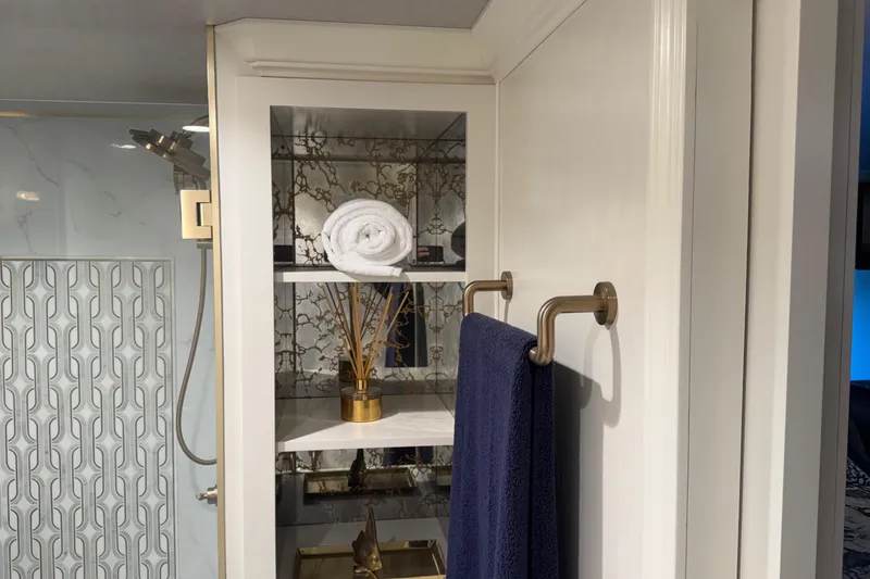 Slide: The Image of Luxurious bathroom with elegant shelving, rolled towel, and decorative accents in a Thoroughbred 20 x 102. - 23