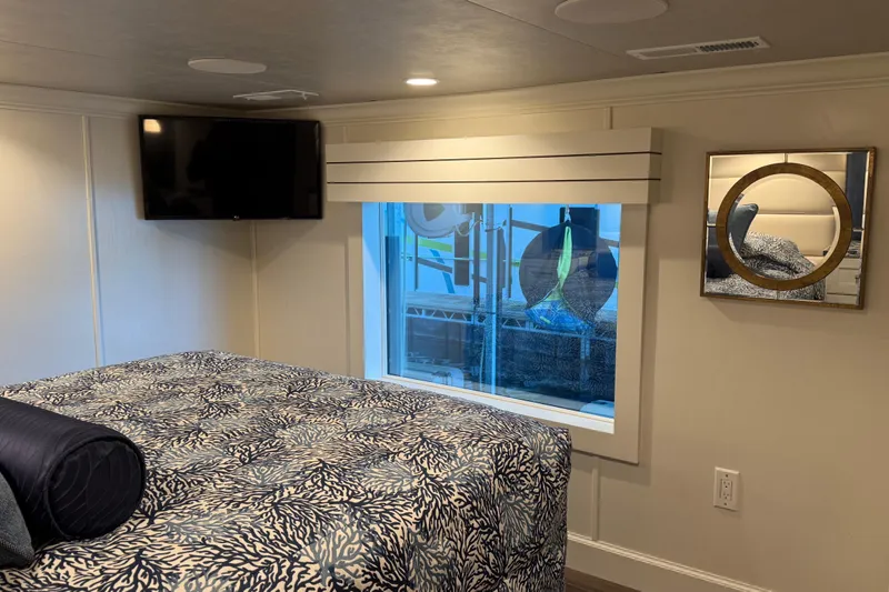Slide: The Image of Modern bedroom interior in a 2020 Thoroughbred 20 x 102, featuring TV and decorative mirror. - 25