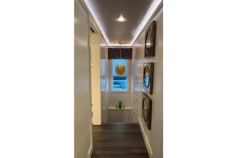 Slide: The Image of Modern hallway with decorative mirrors, pendant light, and window view in Thoroughbred 20 x 102, 2020 model. - 27