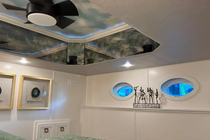 Slide: The Image of Luxurious Thoroughbred 20 x 102 interior with modern decor, ceiling fan, and artistic accents, 2020 model. - 29