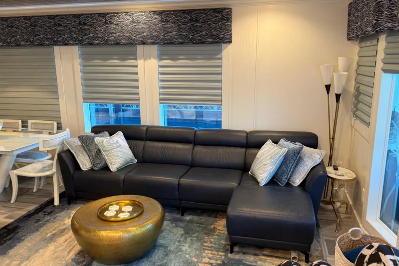 Slide: The Image of Modern living room with black leather sectional, gold coffee table, and stylish decor. - 33