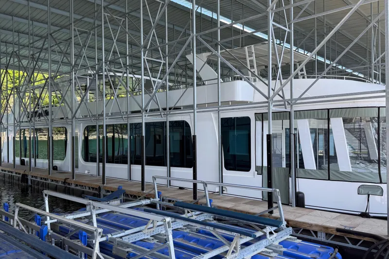Slide: The Image of 2020 Thoroughbred 20 x 102 houseboat docked under metal canopy structure. - 4