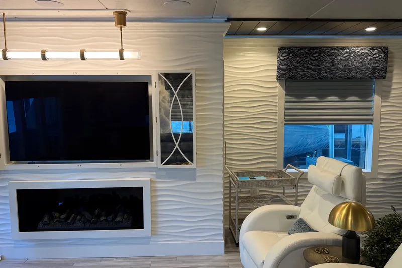 Slide: The Image of Modern living room with TV, fireplace, and recliner in a Thoroughbred 20 x 102, 2020 model. - 41