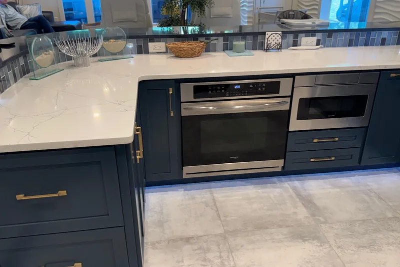 Slide: The Image of Modern kitchen with navy cabinets, marble countertops, and stainless steel appliances, Thoroughbred 20 x 102 model. - 46