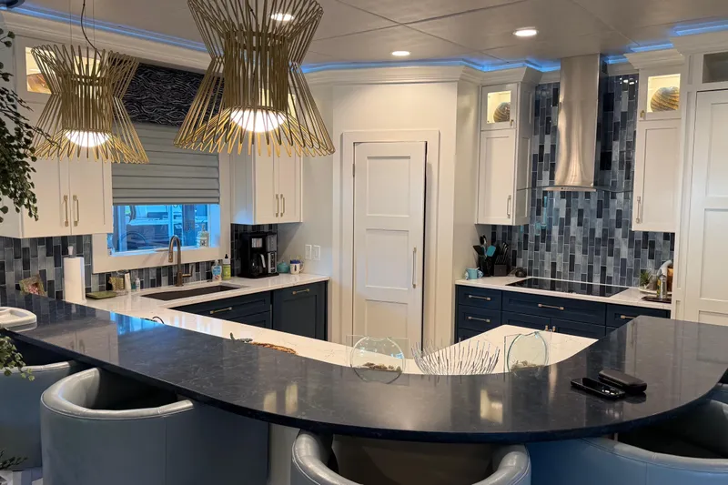 Slide: The Image of Modern kitchen with blue and white cabinetry, stylish lighting, and sleek countertops, Thoroughbred 20 x 102 model. - 48