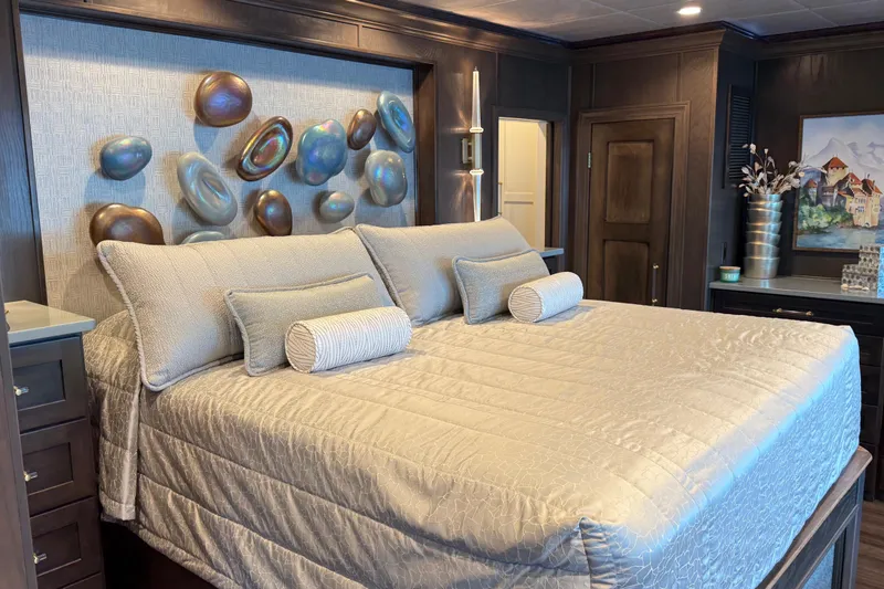Slide: The Image of Luxurious bedroom with elegant decor, featuring a plush bed and artistic wall accents. - 5