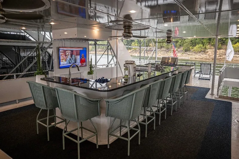 Slide: The Image of Luxurious 2020 Thoroughbred houseboat interior with bar, TV, and scenic river view. - 54