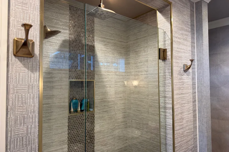 Slide: The Image of Modern glass shower with textured tiles and brass fixtures, Thoroughbred 20 x 102, 2020 model. - 9