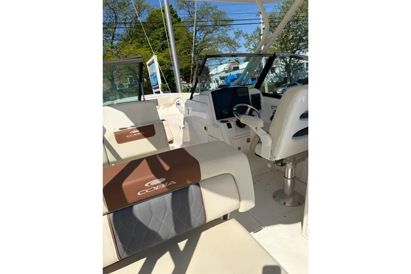 Slide: The Image of 2022 Cobia 280 Dual Console boat interior with seating and helm station. - 2