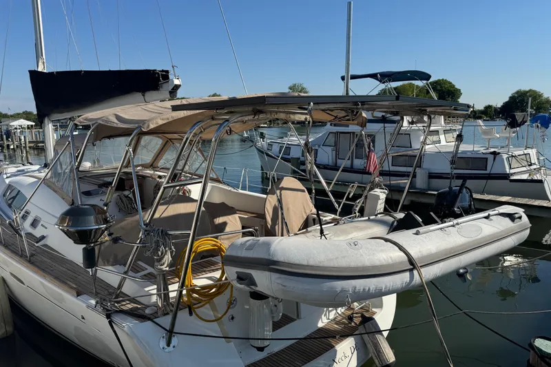 Slide: The Image of 2007 Beneteau Oceanis 49 sailboat docked with inflatable dinghy on deck. - 1