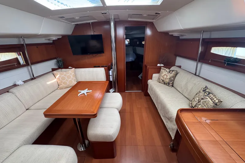 Slide: The Image of Luxurious interior of 2007 Beneteau Oceanis 49 yacht with elegant wood finish and cozy seating. - 11