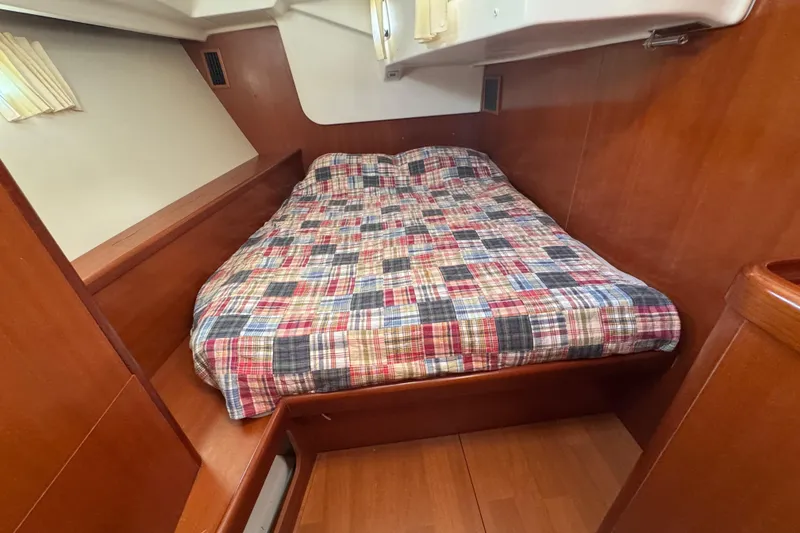 Slide: The Image of Cozy cabin interior of 2007 Beneteau Oceanis 49 with plaid bedding. - 14