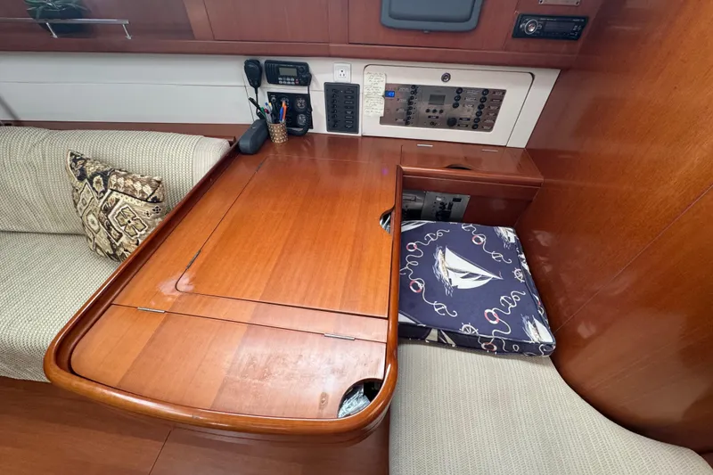 Slide: The Image of Interior of 2007 Beneteau Oceanis 49 yacht with wooden table and navigation equipment. - 15