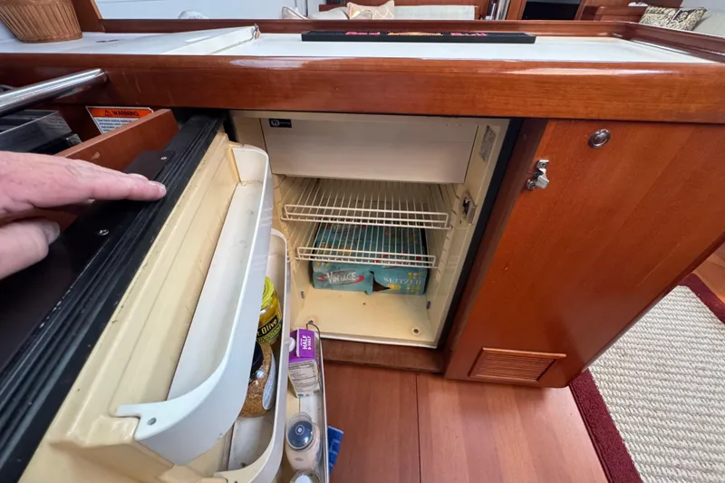 Slide: The Image of Interior view of a 2007 Beneteau Oceanis 49 yacht's compact refrigerator. - 17