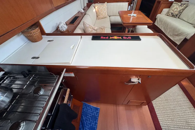 Slide: The Image of Interior of 2007 Beneteau Oceanis 49 yacht with kitchen and seating area. - 18