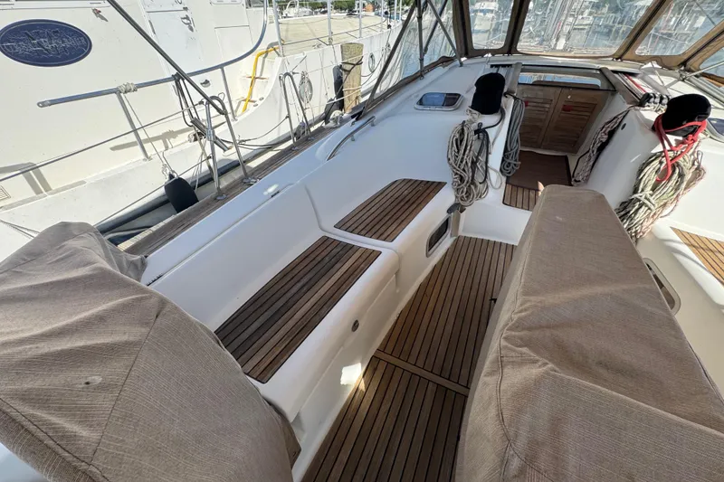 Slide: The Image of Cockpit of 2007 Beneteau Oceanis 49 sailboat with teak flooring and covered seating. - 21
